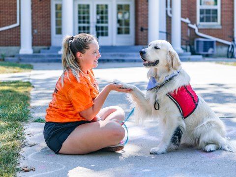 Photo of Madyson working with a service dog