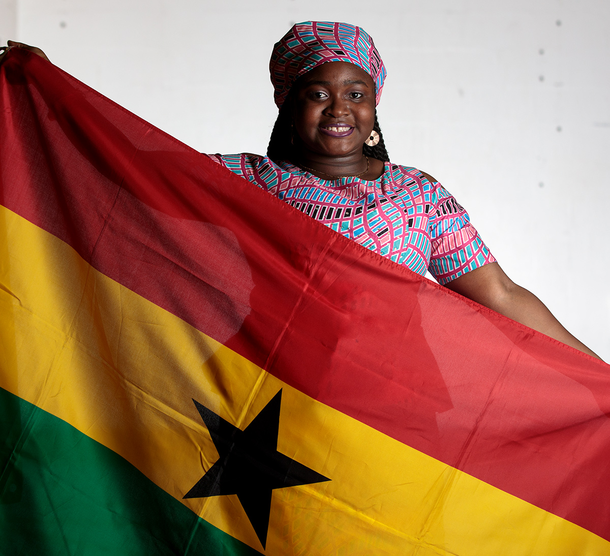 Amara Egbujor with a Ghanaian flag