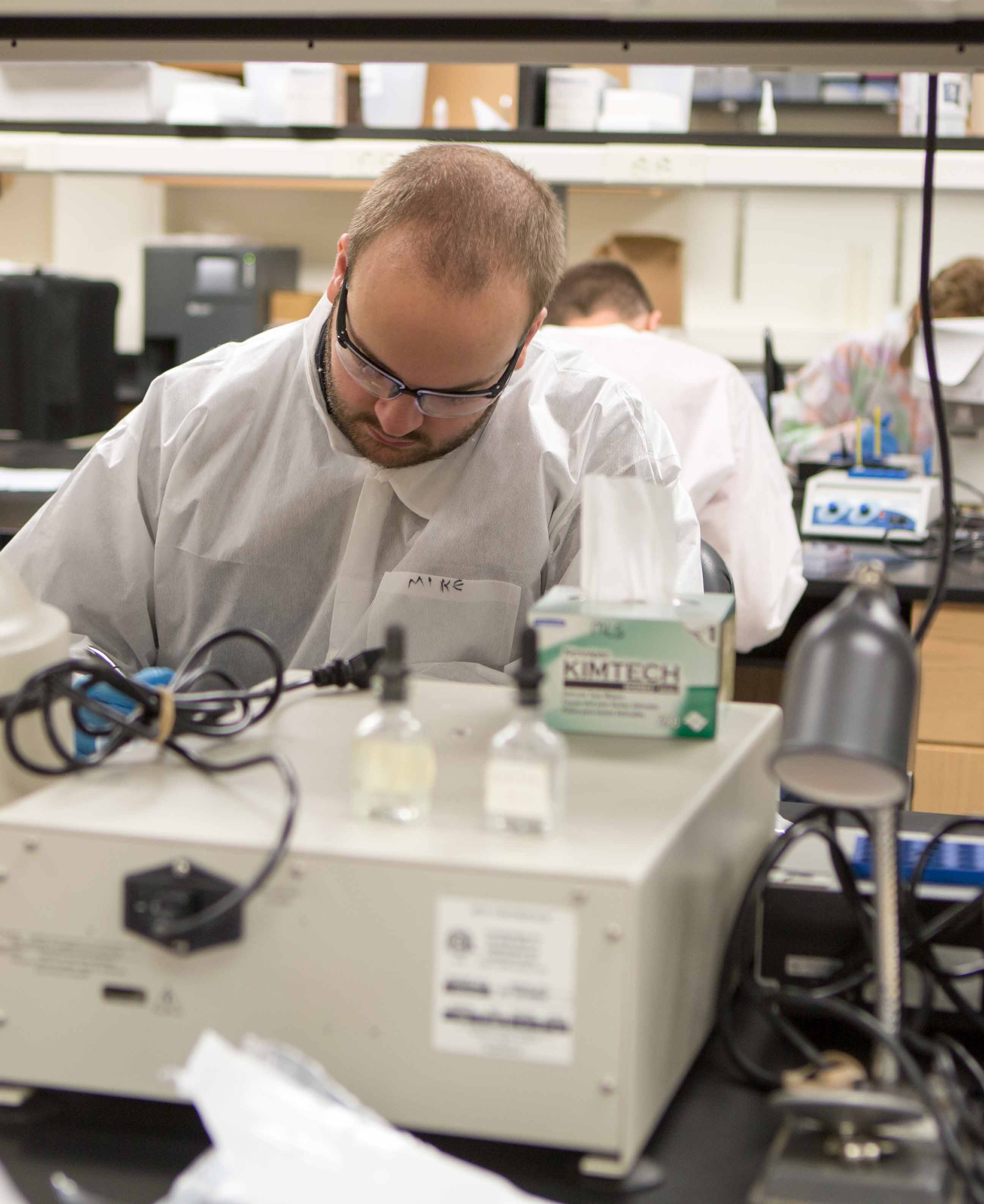 forensic biology student working in lab