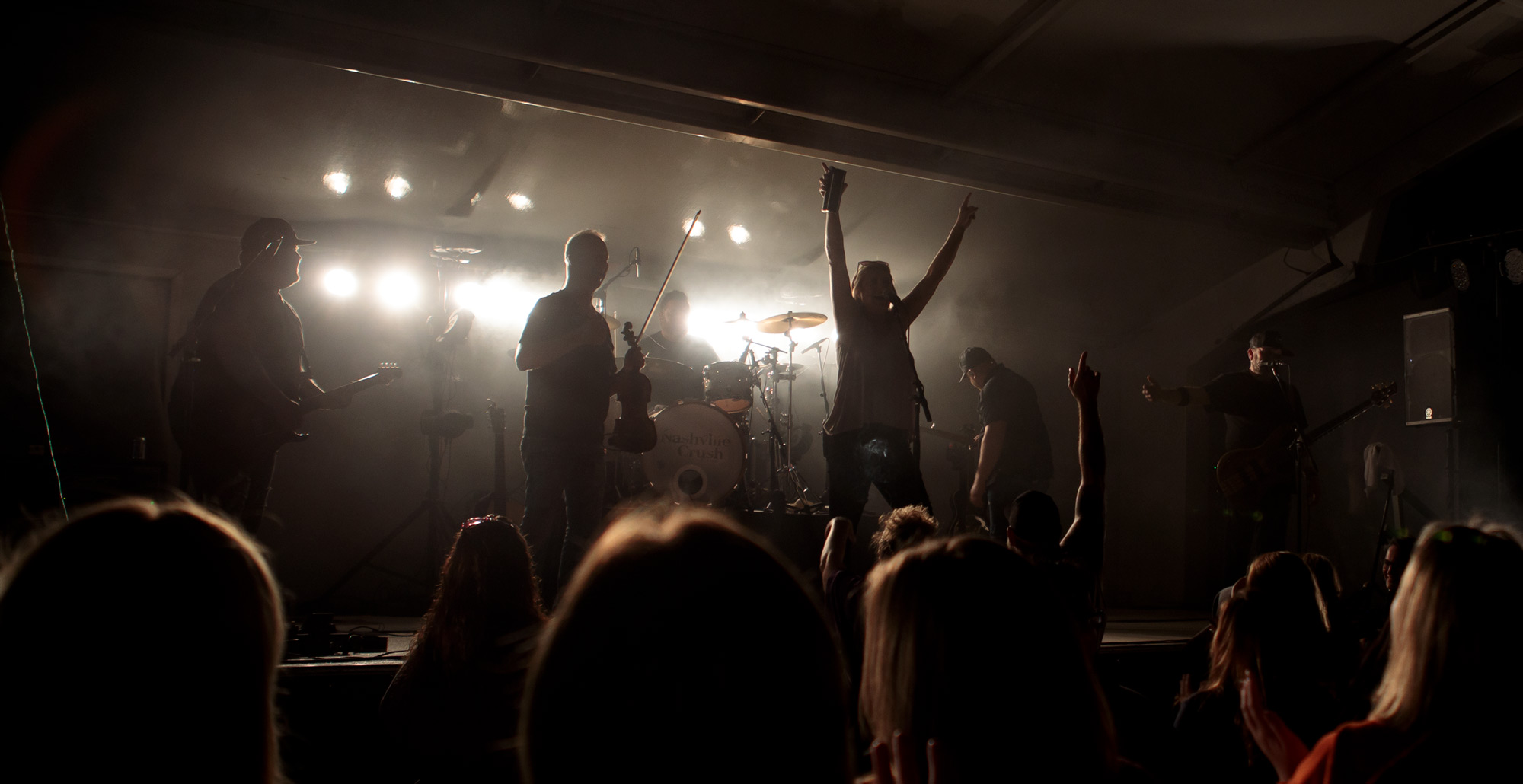 A fan joins Nashville Crush on stage. 