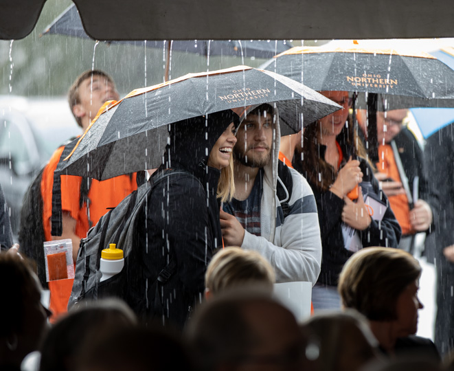 Students weather the weather to attend the dedication.