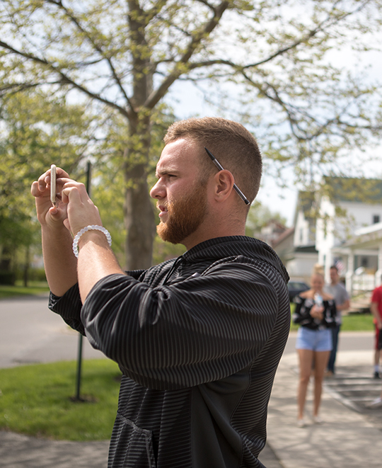 Student outside taking picture