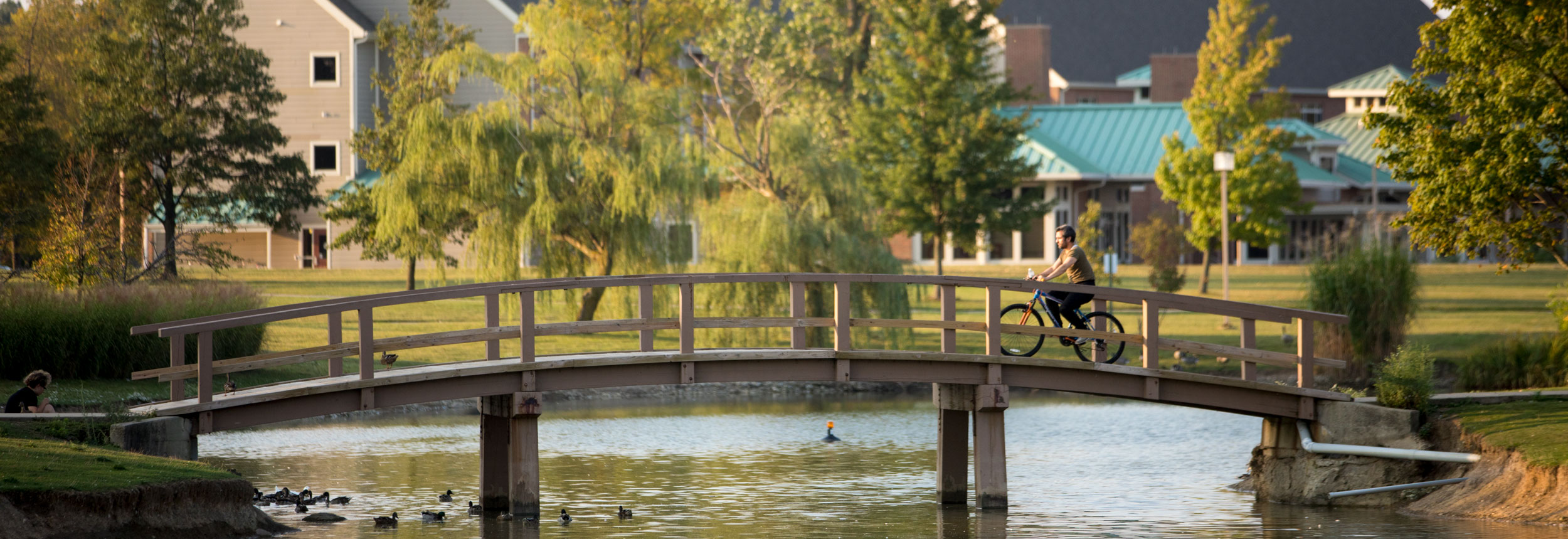 Student rides bike across campus.