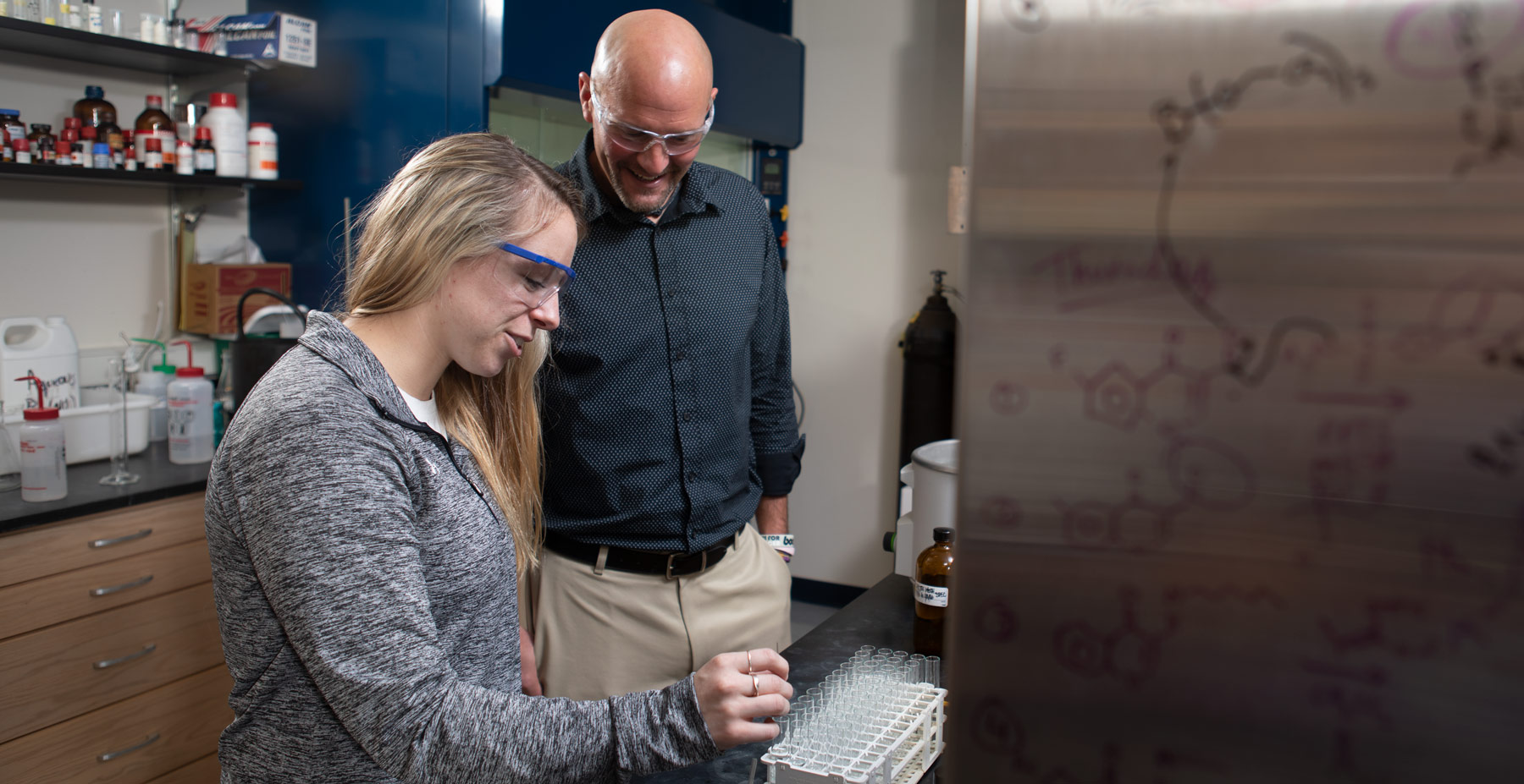 financial aid professor and student working in the lab