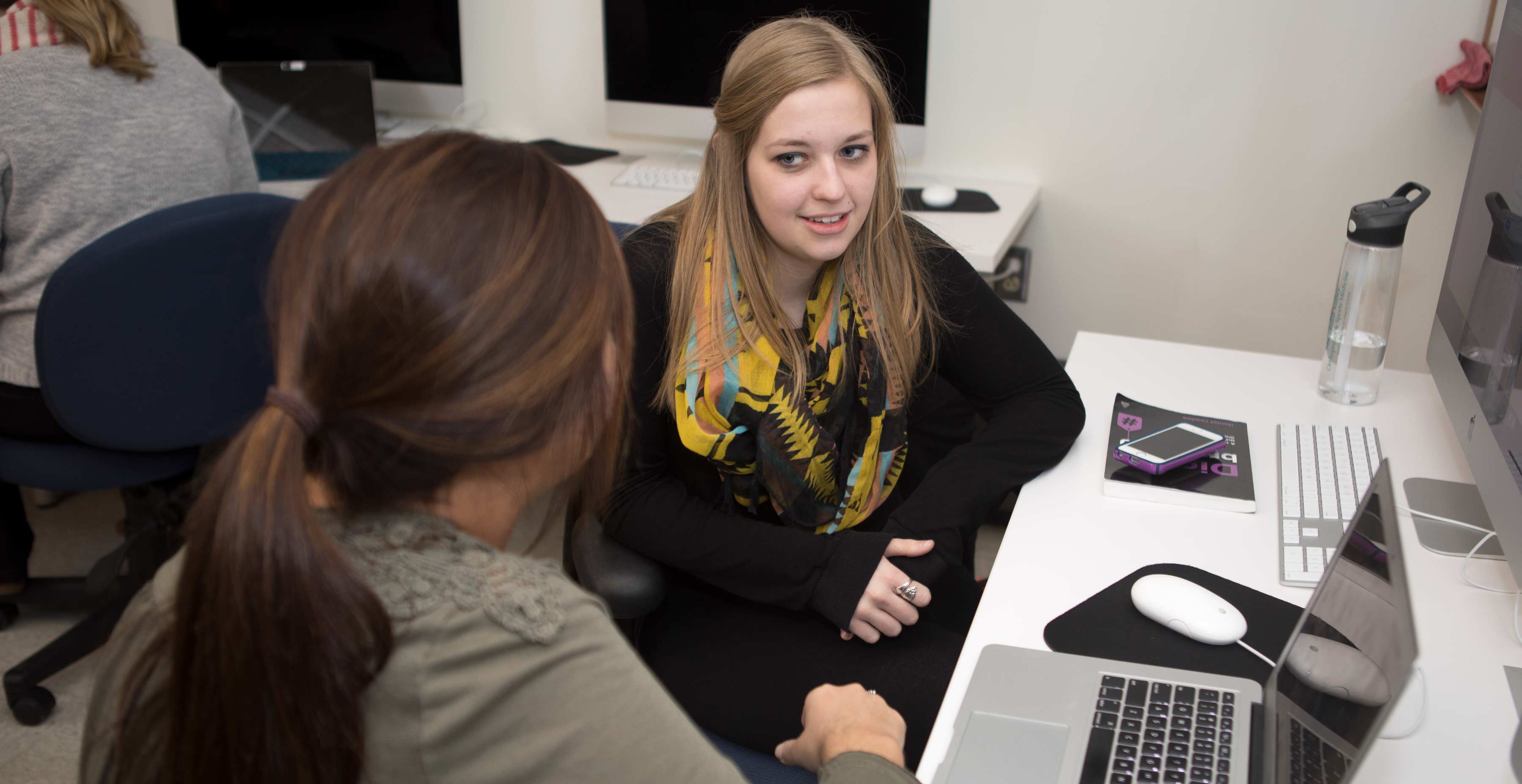 A student smiling during her PRSSA meeting.