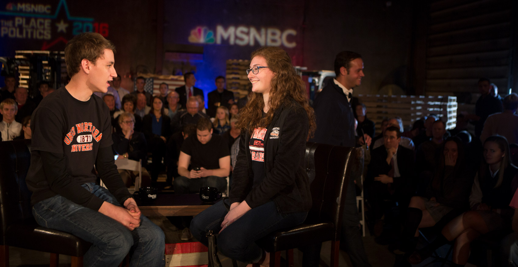 Ohio Northern University student sits on the stage during a technical check before a town hall meeting.