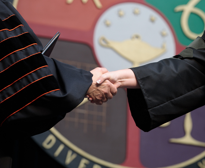 Handshake in front to the ONU University seal