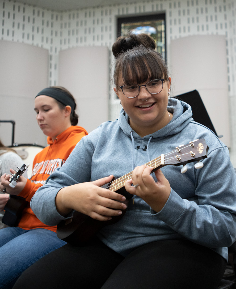 Students work on integrated music methods during a music education class.