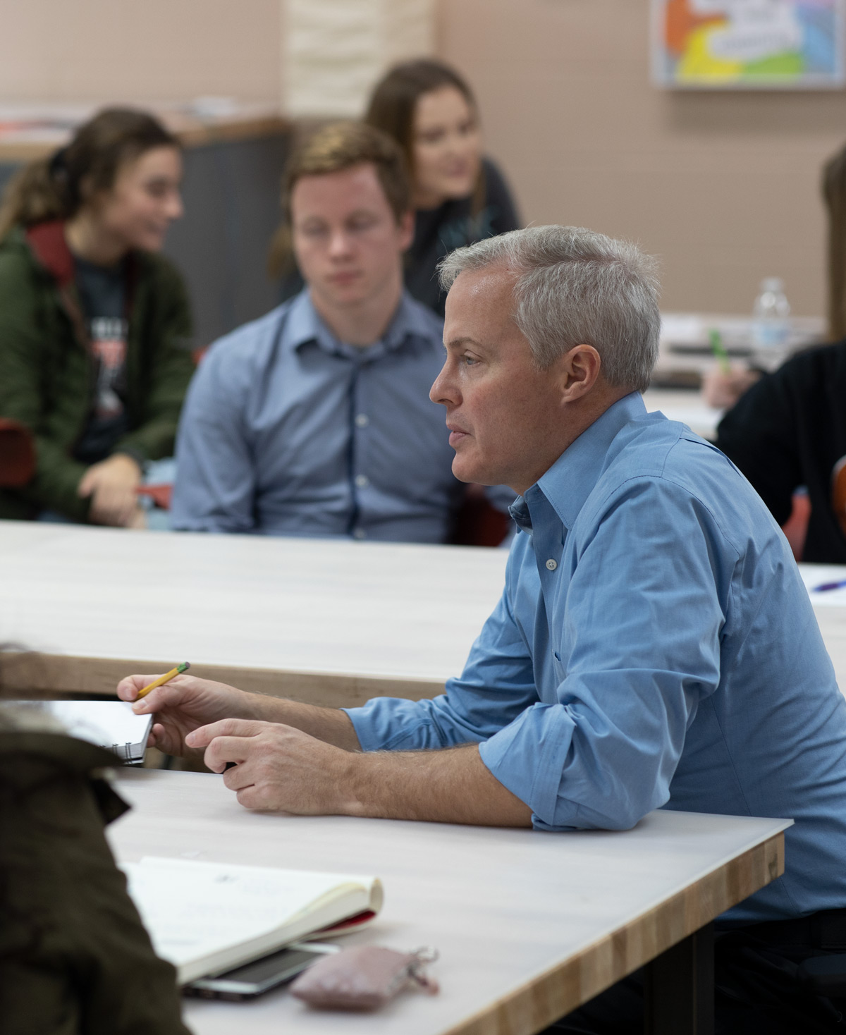 Professor of Graphic Design teaching to a class of students.