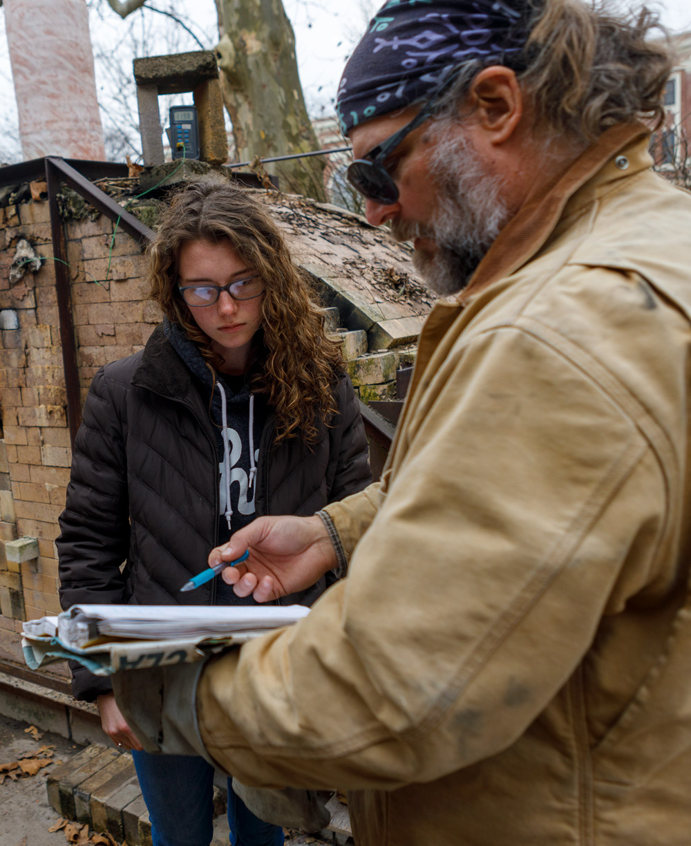 Professor of Art and Design works together with a student on a project in the Wilson Art Building.