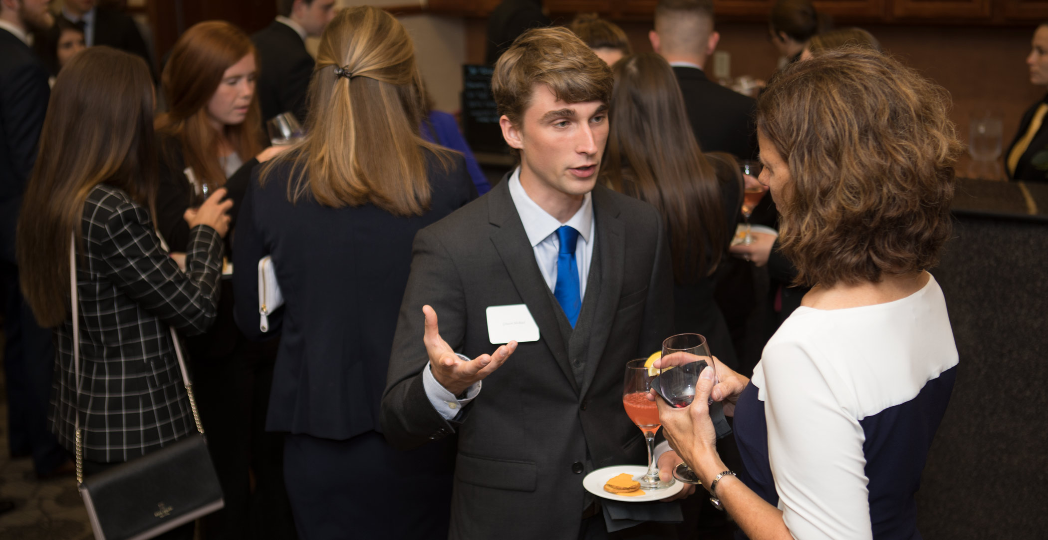 Patty Navin speaks with Graeson Michaud. Ohio Northern University Dicke College of Business Administration juniors participated in an etiquette dinner at The Inn at Ohio Northern University.