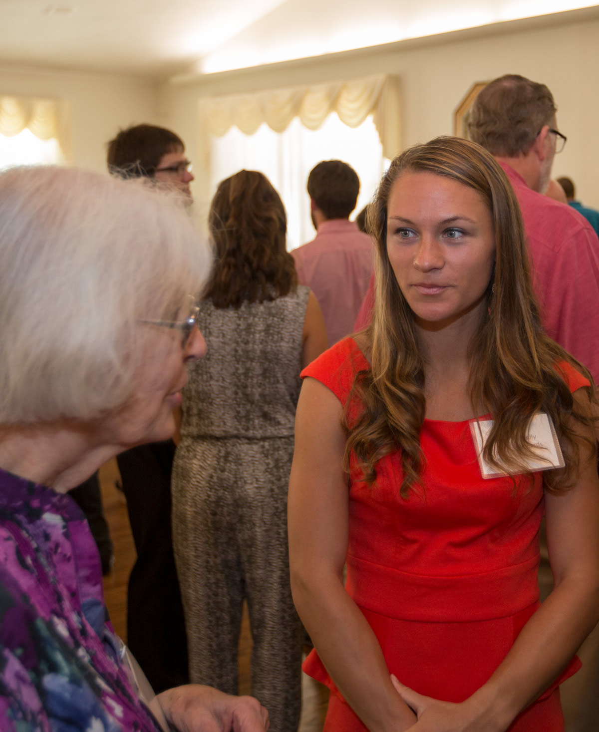 A student celebrating with guests during a scholarship dinner.