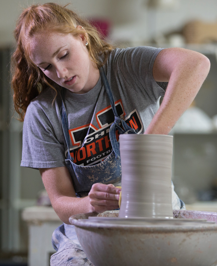 studio arts student creating pottery. 