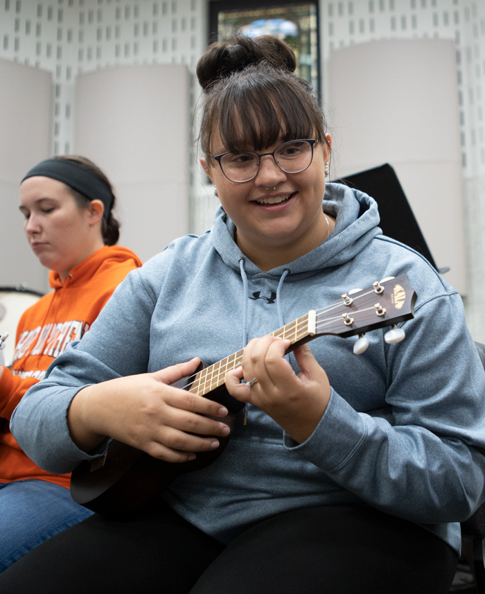 music education student performs in a music class.