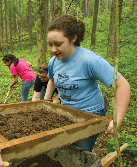 students working outside during a field study experience. 