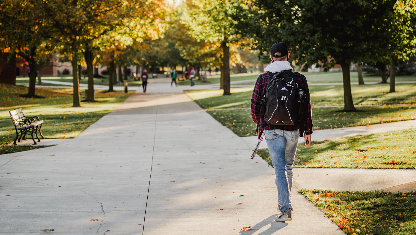 student walks across campus.