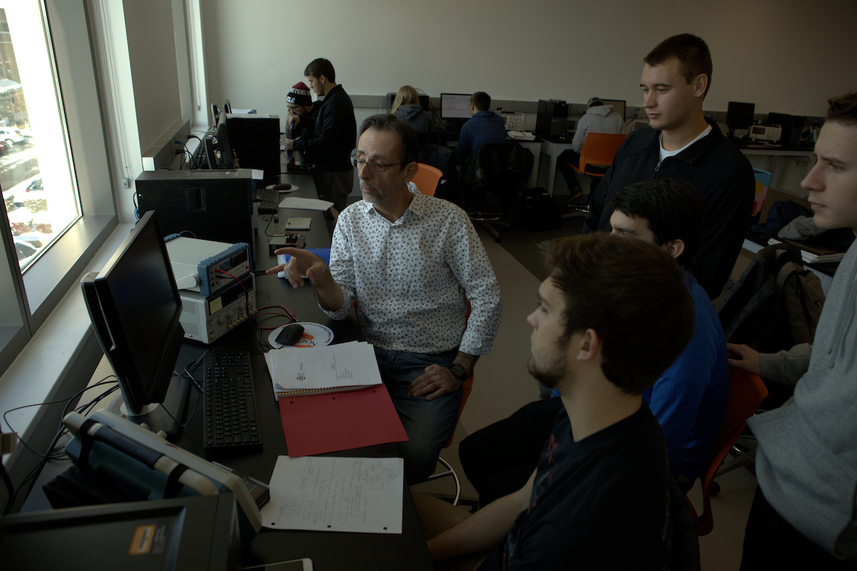 Student working with a professor in class for computer science