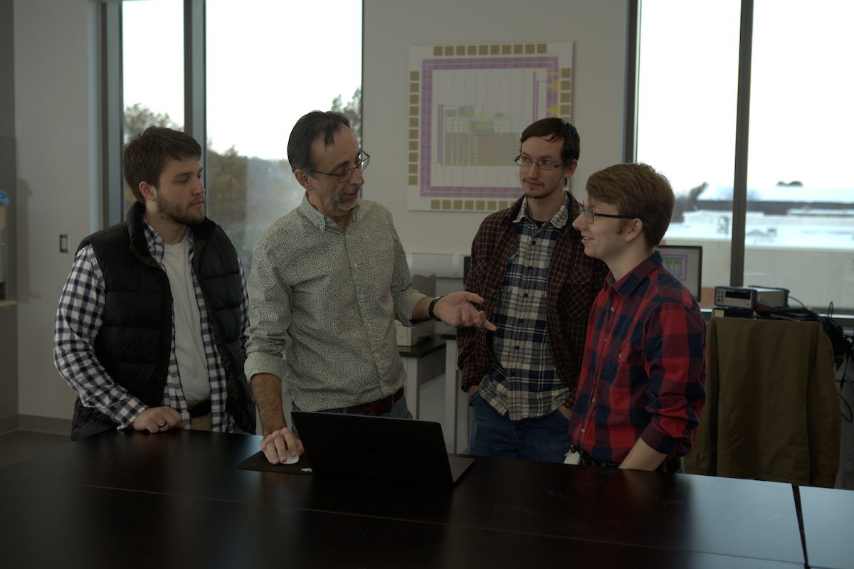 Professor engaging students in computer science class