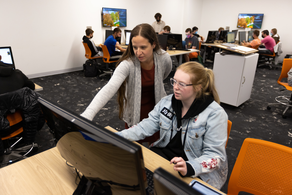 Female student requesting help from a computer science professor