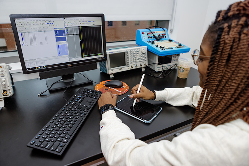 Computer Engineering student on a computer