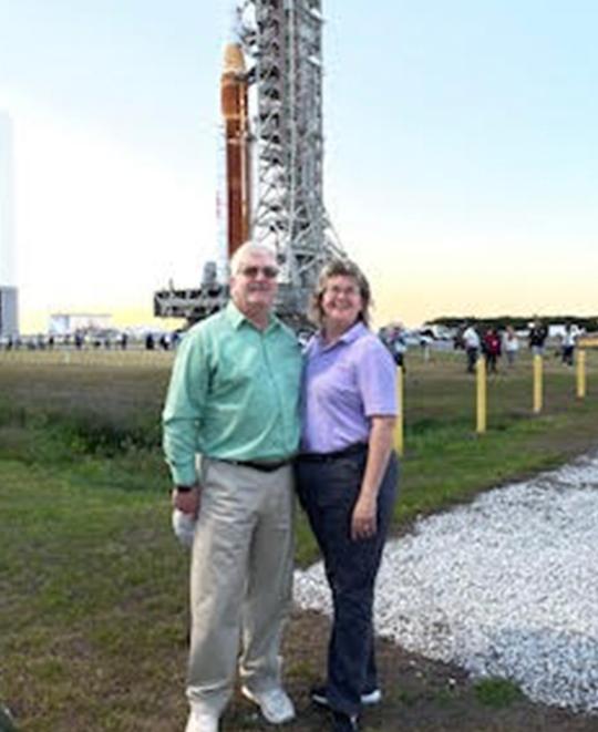 Artemis rocket photo with the Moore's posing in front of it