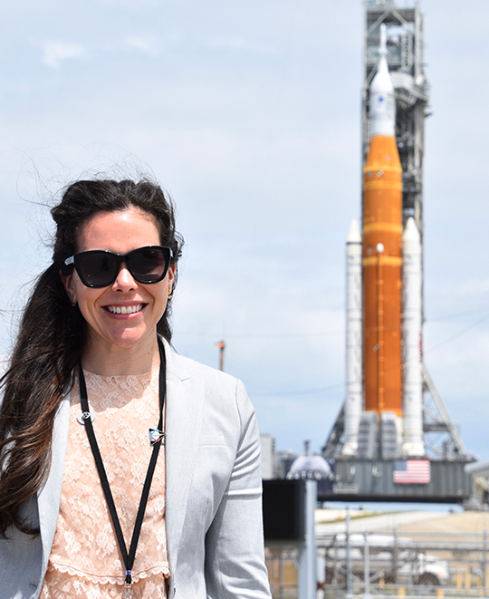 Artemis rocket photo with Katie Oriti posing in front of it