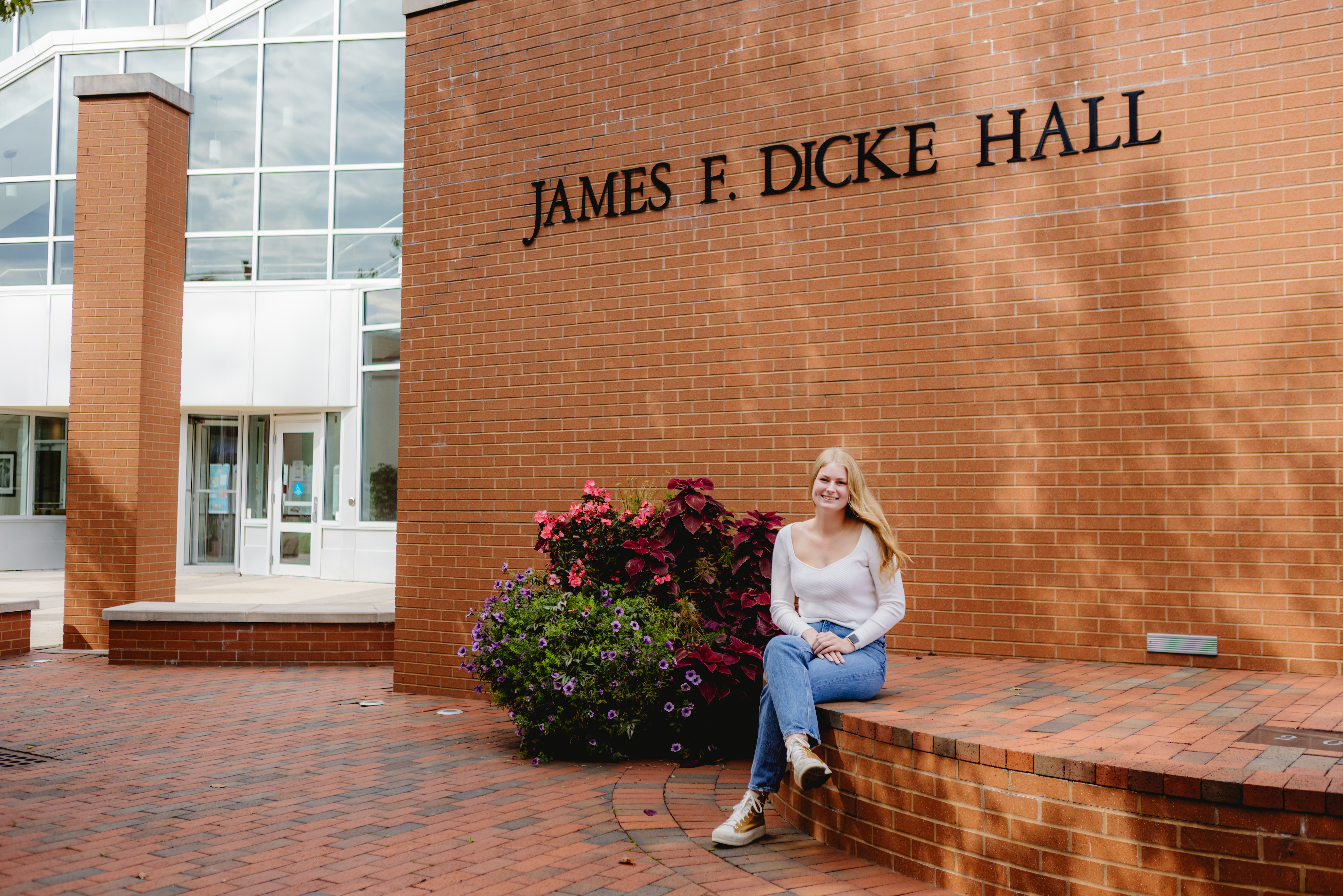 Photo of Allison on a bench in front of Dicke Hall