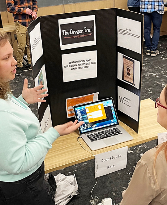 Photo of a student presenting her programming project