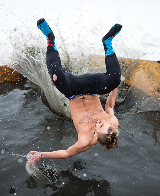 student jumping into cold water at polar plunge