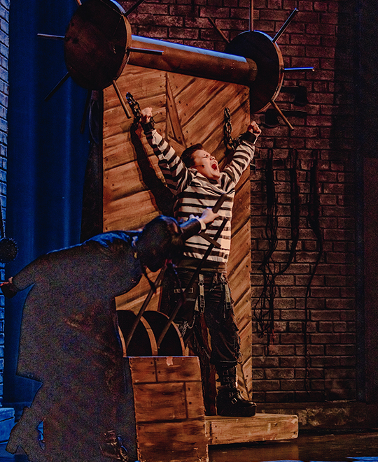 Students perform on stage during a rehearsal of The Addams Family