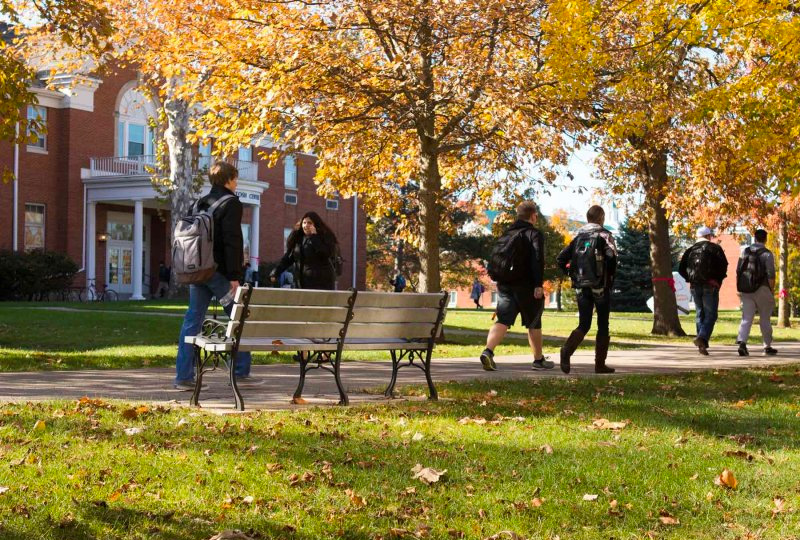 Photo of ONU fall leaves and students walking