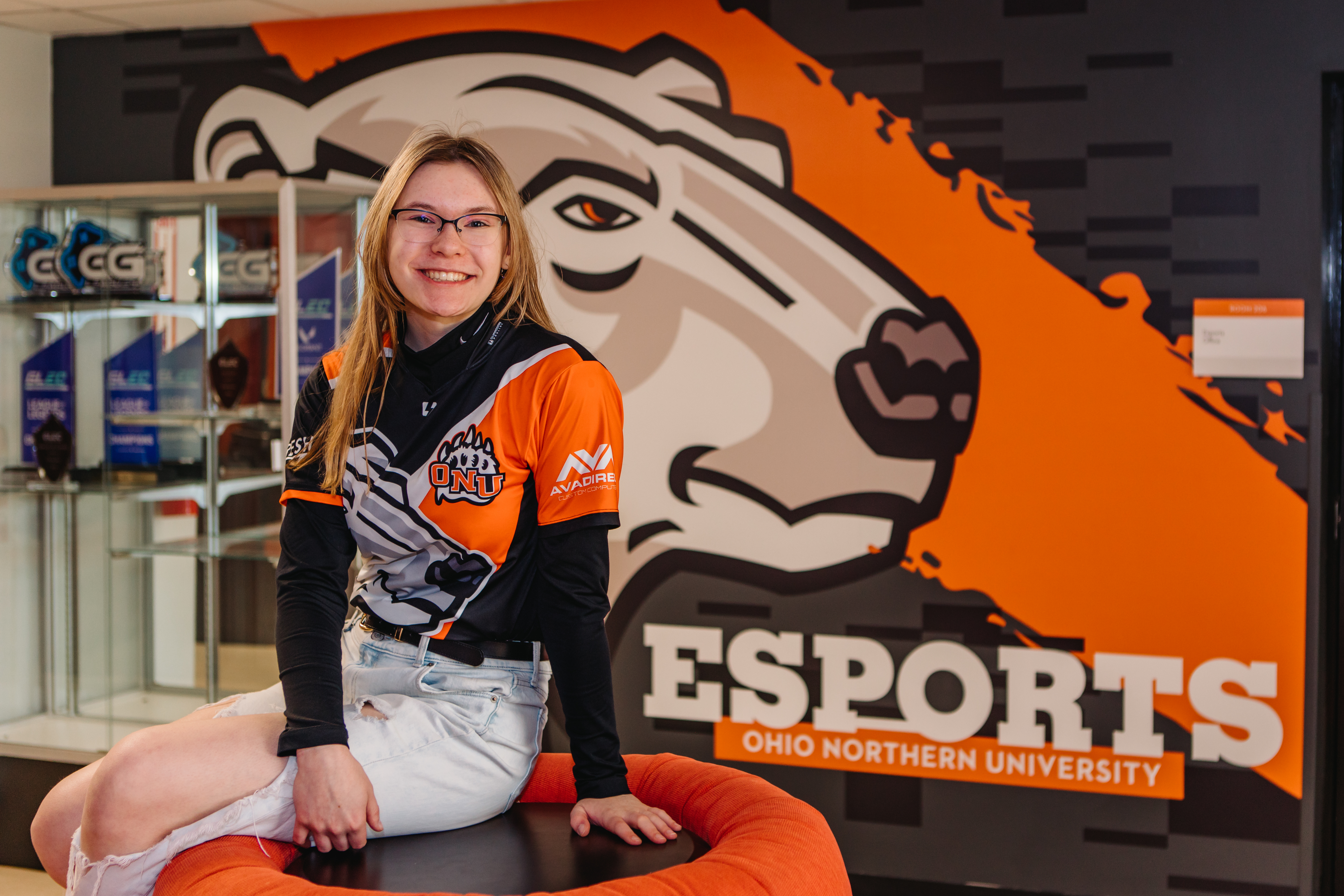 Photo of Maria in front of ESports signage