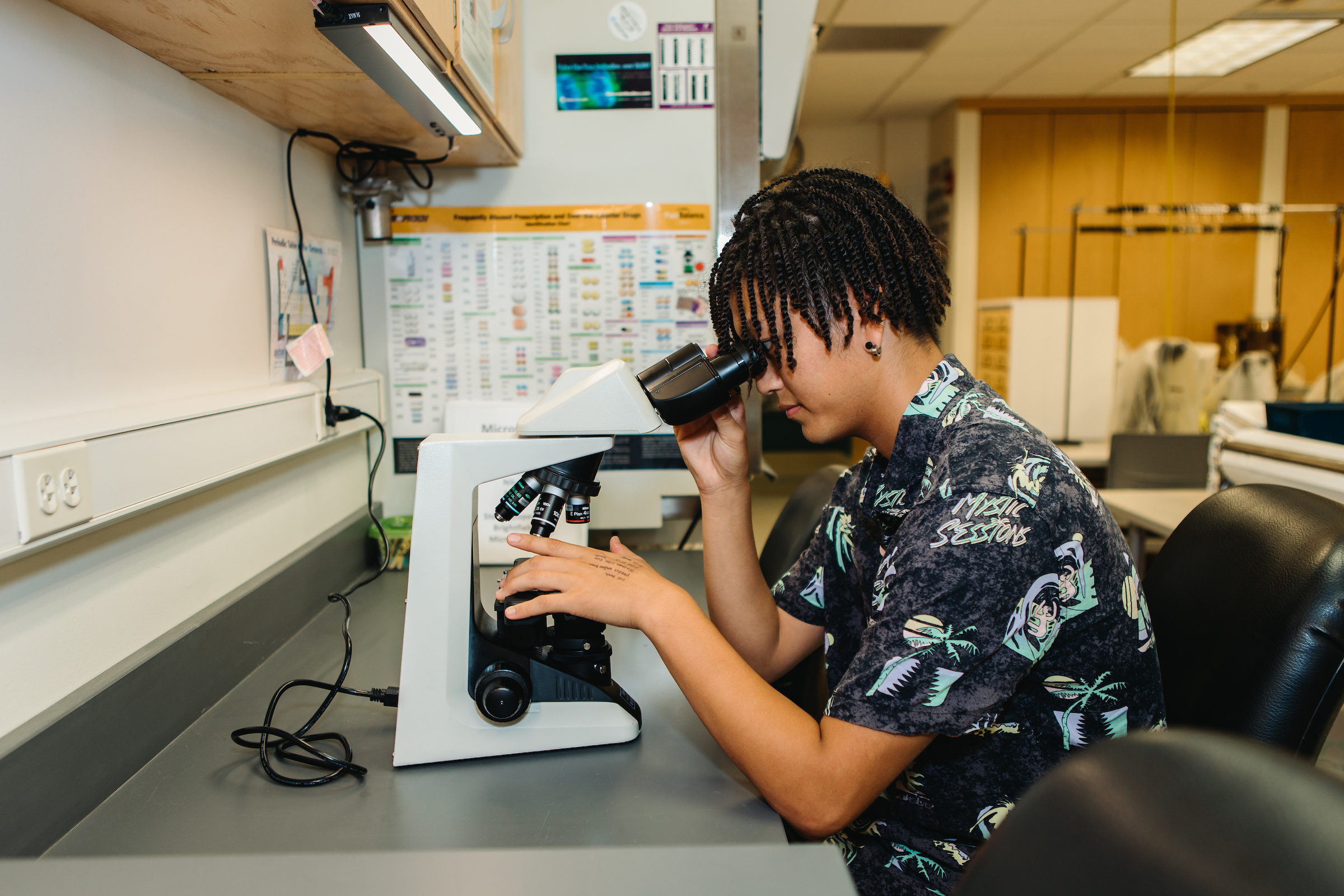 Photo of Kanami at a microscope