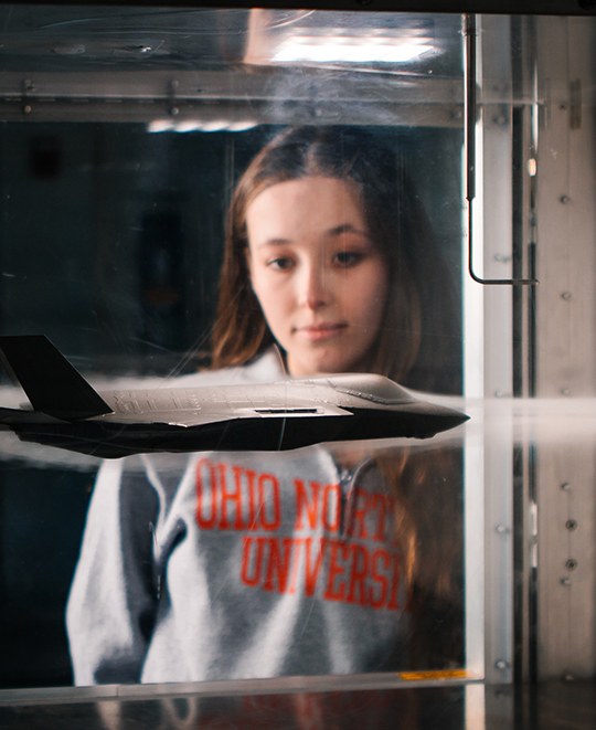 Photo of Student looking at her project