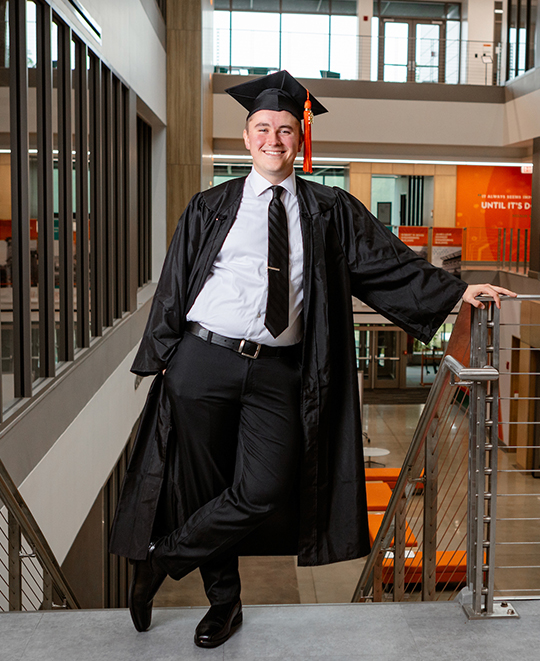Photo of Gavin in his graduation cap and gown