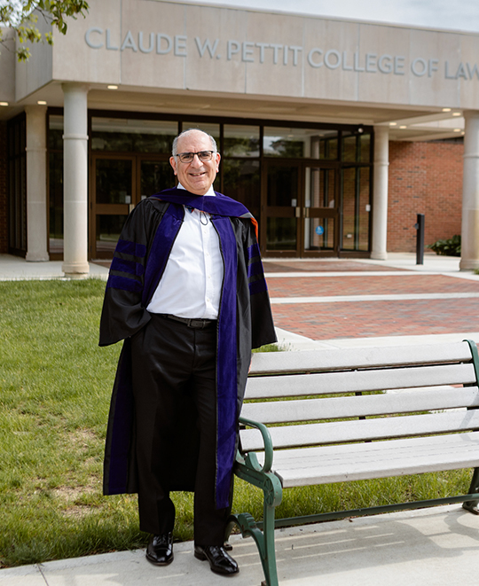 Photo of Mort in his graduation garb