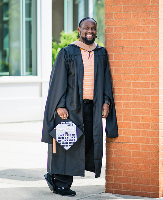 Photo of Xavier in his cap and gown