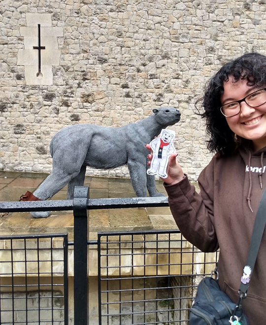 Photo of ONU student holding a 'flat Klondike' near a polar bear statue 