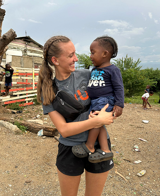 Photo of ONU Nursing Student holding a local child