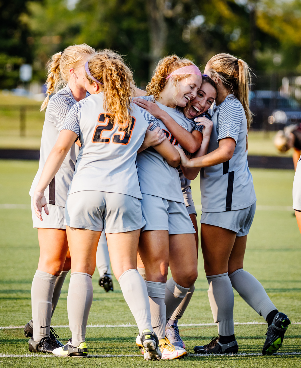 womens soccer team celebrating a win