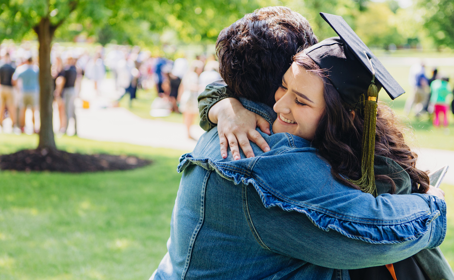 student hugging their parent on graduation day