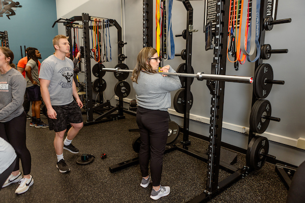 student lifting the bar