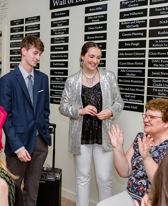 Photo of ONU students that were in the fashion show talking with audience