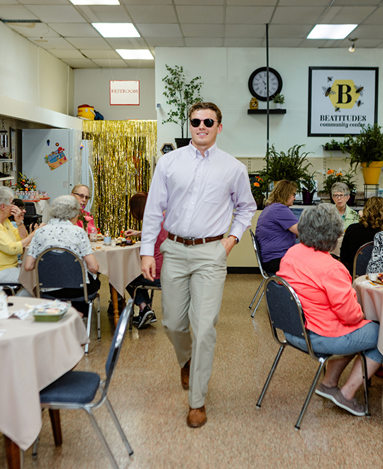Photo of another male ONU student walking the fashion runway