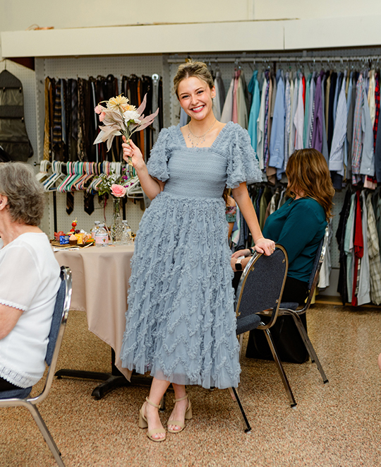 Photo of female ONU student walking the fashion runway in a blue dress