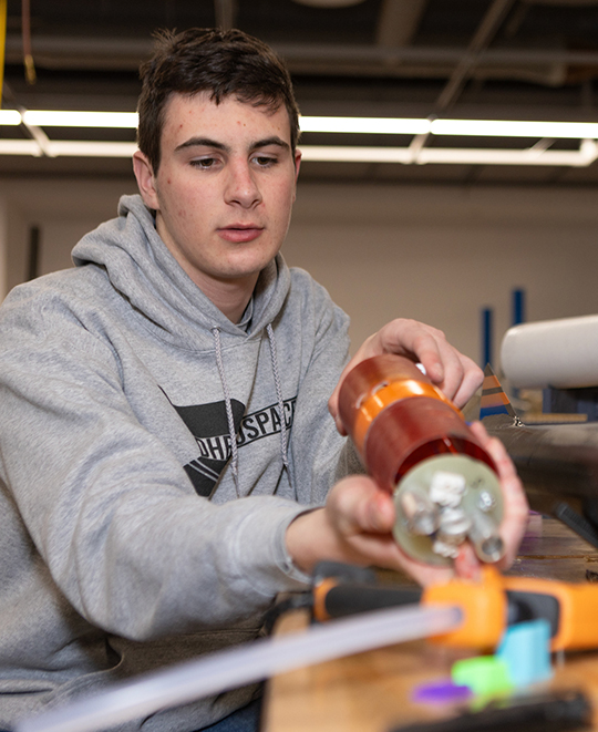 Photo of an ONU student building a rocket
