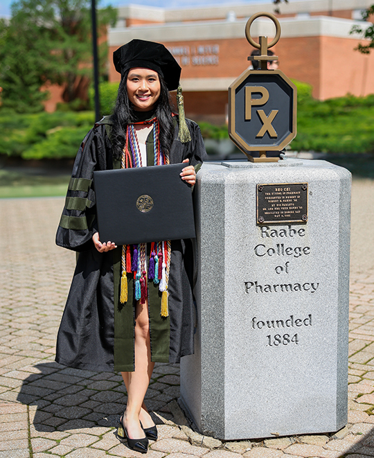 Photo of Brianna standing next to ONU Pharmacy statue