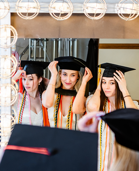 Photo of the sisters backstage looking in the mirror