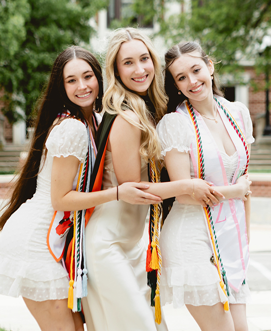 Photo of the sisters posing and holding each other