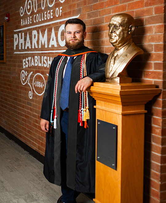 Photo of Reese standing next to ONU statue